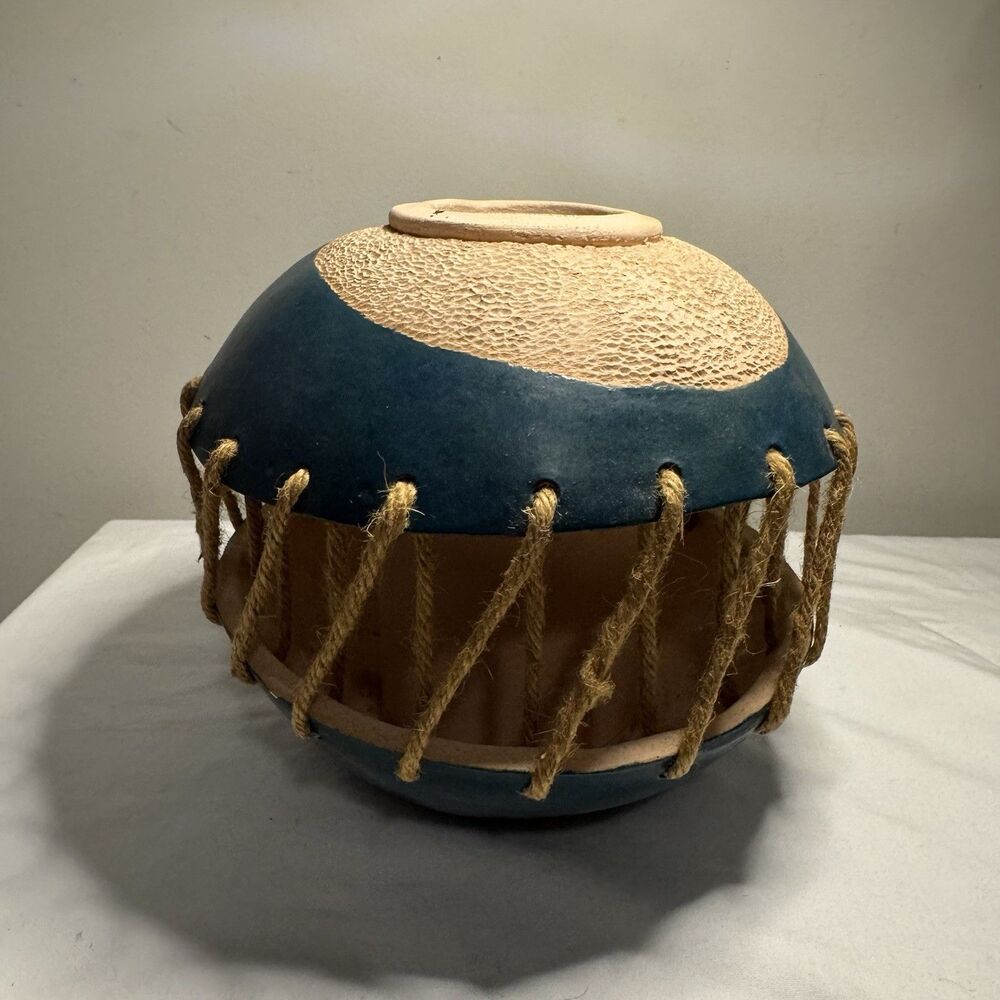 Unique Vase teal and textured tan body laced together with thick rope bindings.
